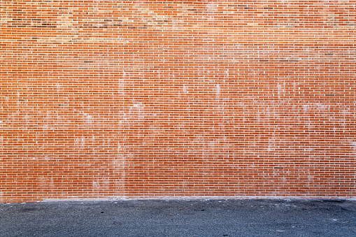 Huge brick wall and asphalt